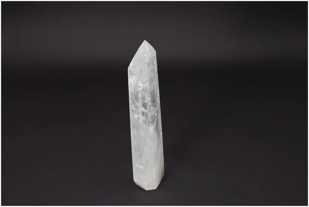 Lemurian Quartz Obelisk on black background, known as Master Healer crystal for clarity and balance.