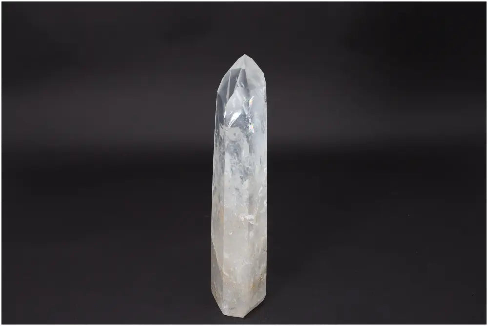 Lemurian Quartz Obelisk on black background, ideal for energy amplification and personal growth in crystal healing practices.