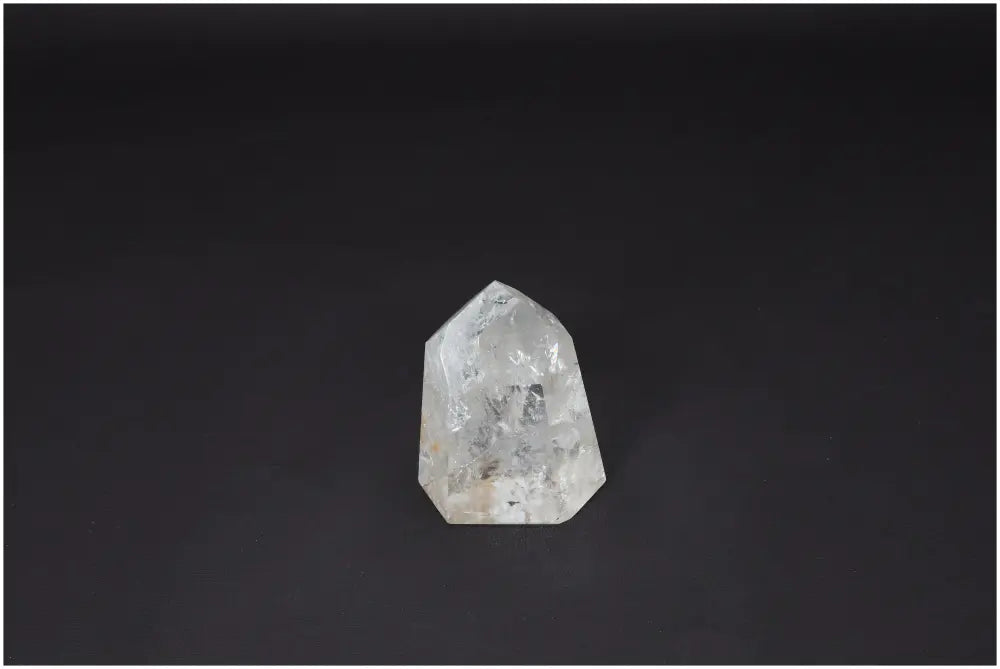 Lemurian Quartz Obelisk crystal on a dark background, known for clarity and healing energy.