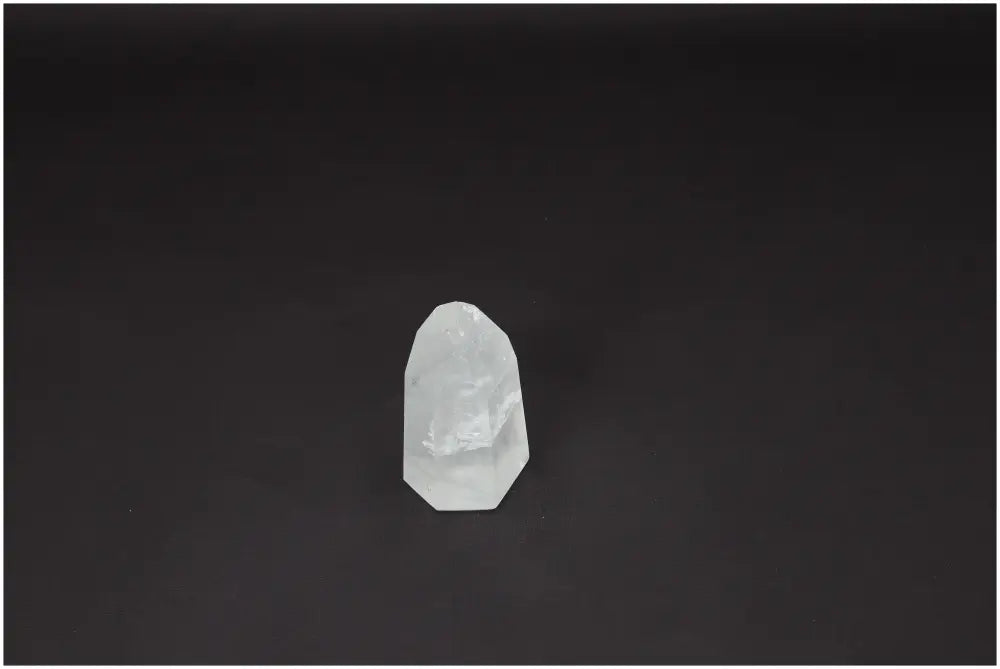Lemurian Quartz Obelisk on dark background, used for clarity and healing, known as the 'Master Healer' crystal, ethically sourced.