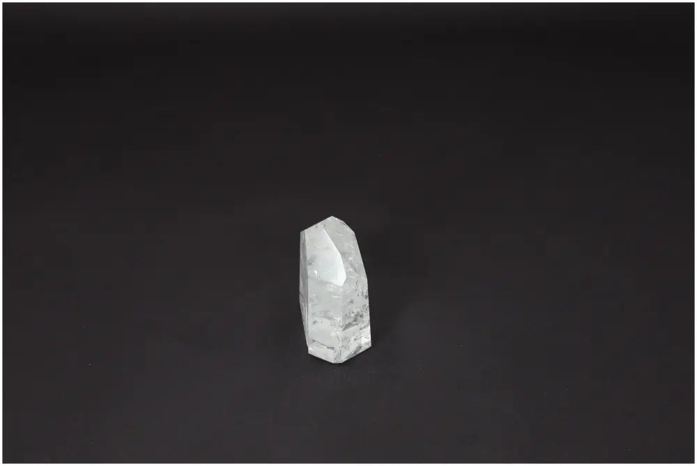 Lemurian Quartz Obelisk on dark background, known for amplifying energy and enhancing personal growth, ethically sourced and naturally formed.