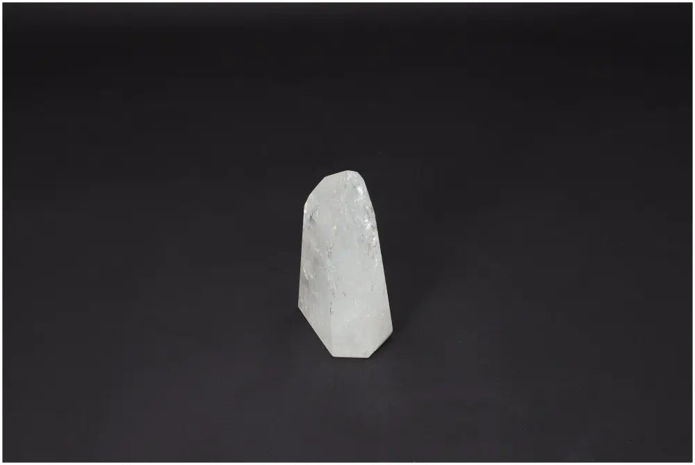 Lemurian Quartz Obelisk on dark background, known as "Master Healer," amplifies energy, enhances clarity and personal growth.