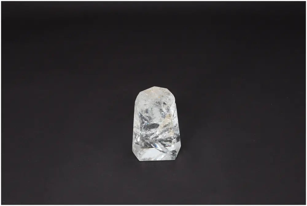 Clear Lemurian Quartz Obelisk on black background, symbolizing clarity and balance, ethically sourced and naturally formed.