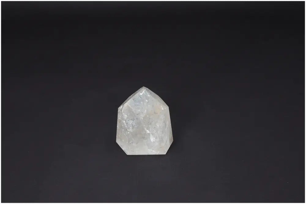 Lemurian Quartz Obelisk on a dark background, showcasing its clear, naturally formed crystal structure, perfect for personal growth and balance.