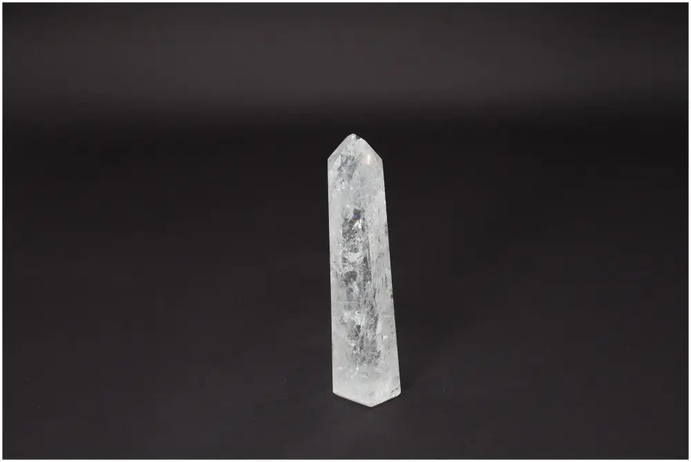Lemurian Quartz Obelisk on dark background, known as a "Master Healer" crystal for clarity, balance, and personal growth.