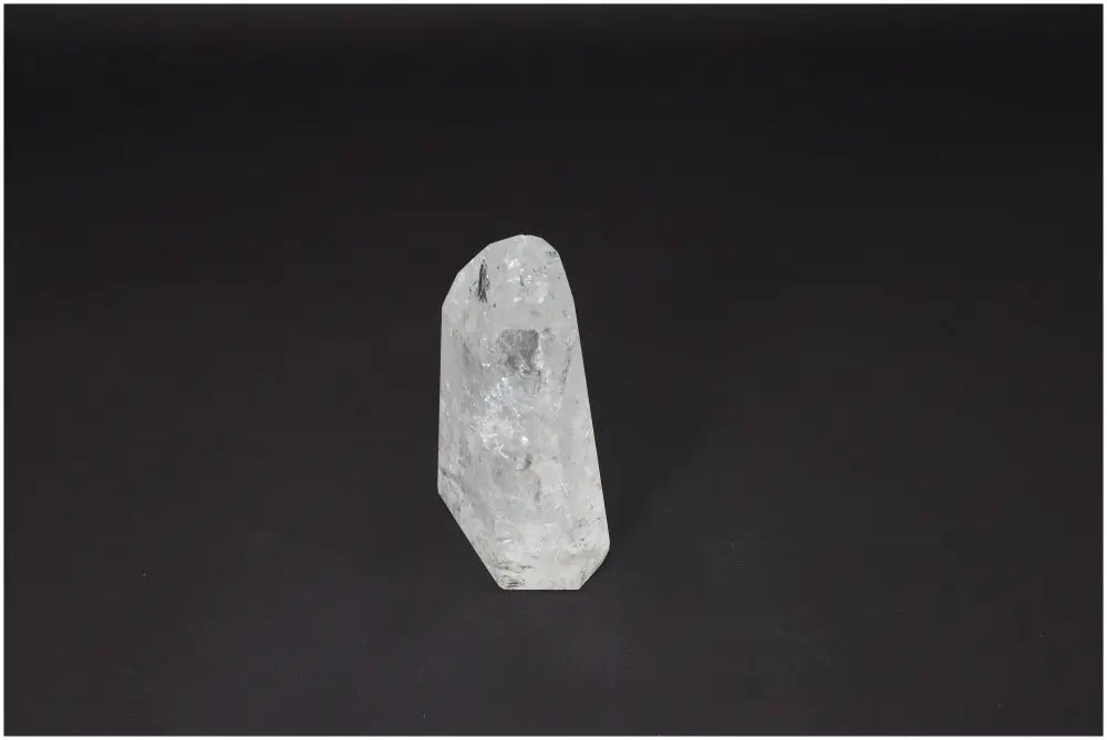 Lemurian Quartz Obelisk on black background, showcasing its clear, faceted form used for clarity, balance, and personal growth.