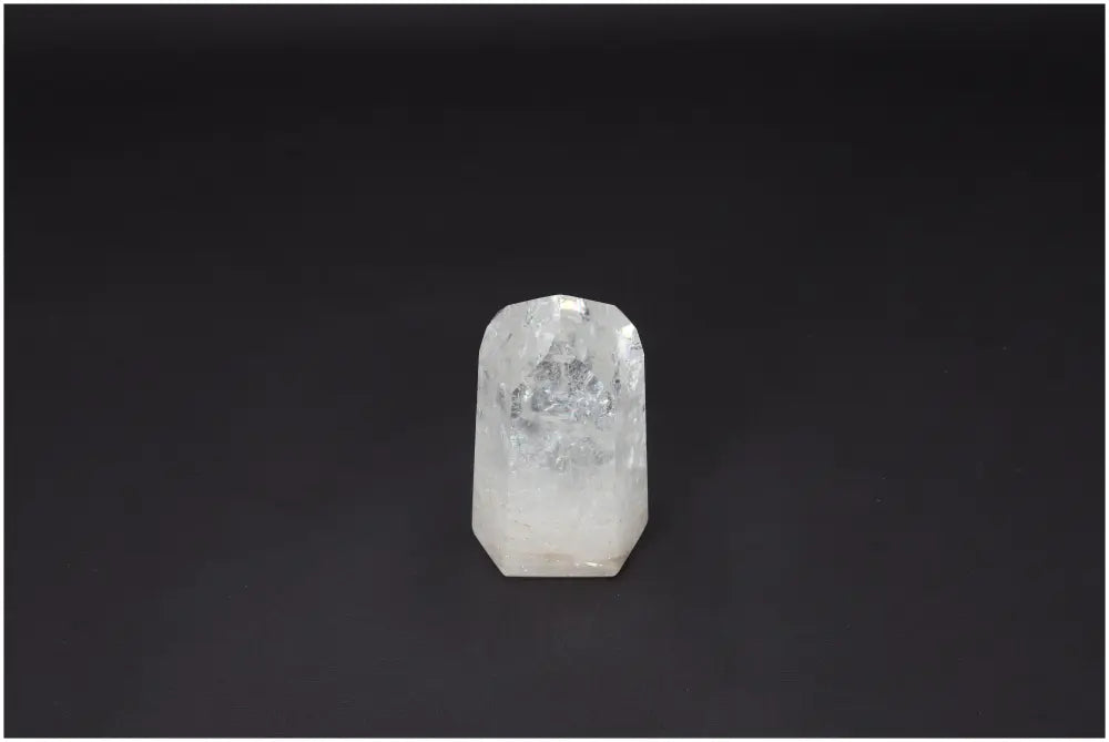 Lemurian Quartz Obelisk with clear crystal structure on dark background, ideal for energy amplification and personal growth.