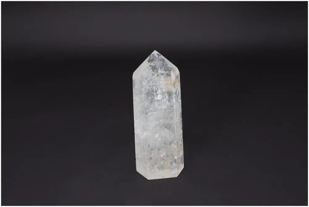 Lemurian Quartz Obelisk on dark background, showcasing clear crystal structure for energy amplification and healing.
