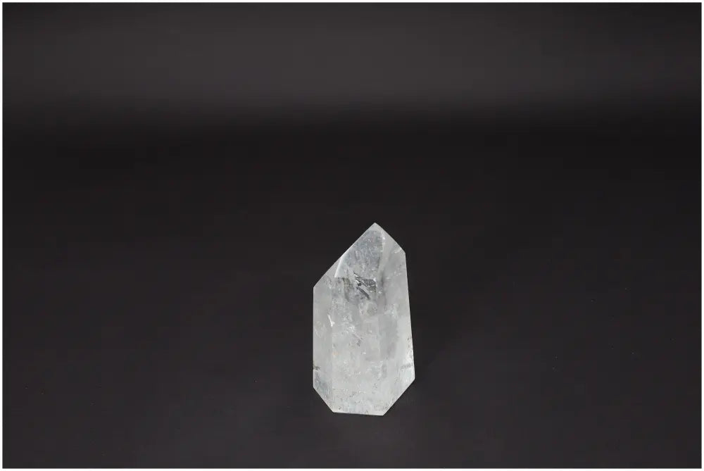 Lemurian Quartz Obelisk on a dark background, known for clarity, balance, and growth. Ethically sourced, master healer crystal product.