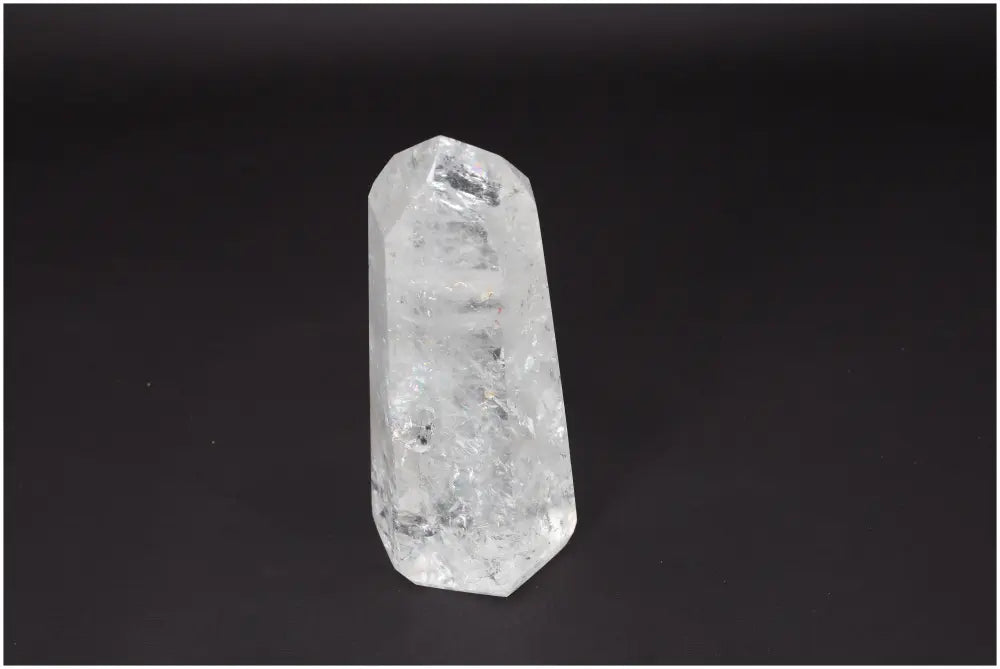 Lemurian Quartz Obelisk on dark background, showcasing its clear crystal structure. Ideal for clarity, balance, and spiritual growth.