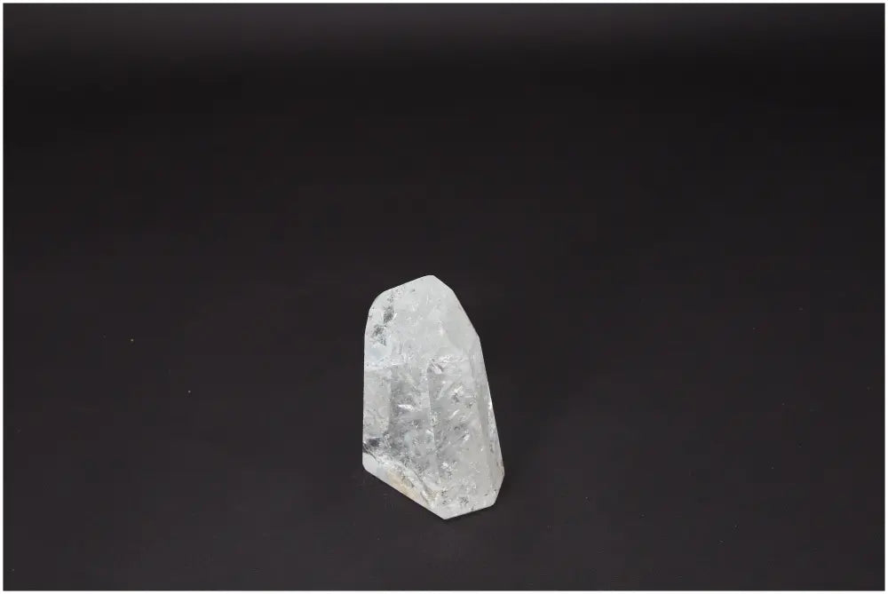 Lemurian Quartz Obelisk crystal against a dark background, highlighting its clarity and natural form, ideal for energy amplification and healing.
