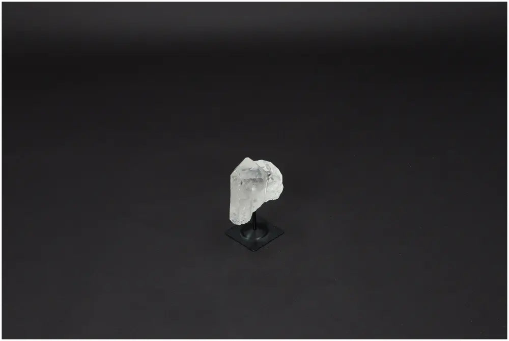Lemurian Quartz crystal on a metal stand against a dark background, symbolizing clarity, balance, and personal growth.