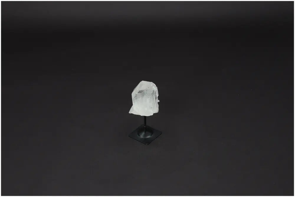 Lemurian Quartz Crystal on Metal Stand, a hand-selected piece for clarity and personal growth, set against a dark background.