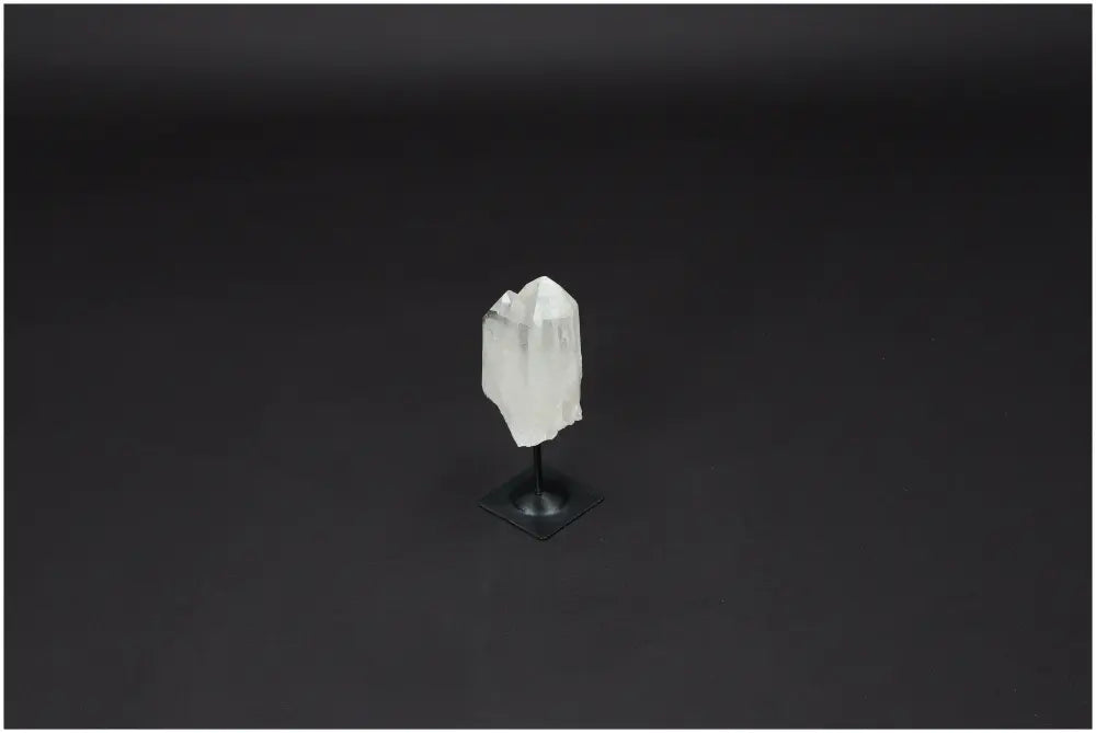 Lemurian Clear Quartz crystal on a metal stand, known as the "Master Healer," enhances clarity and personal growth.
