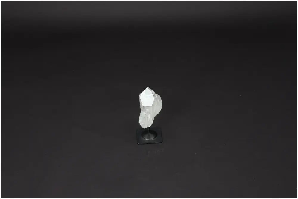 Lemurian Quartz crystal on a metal stand, offering clarity and balance as a master healer in personal growth and well-being.