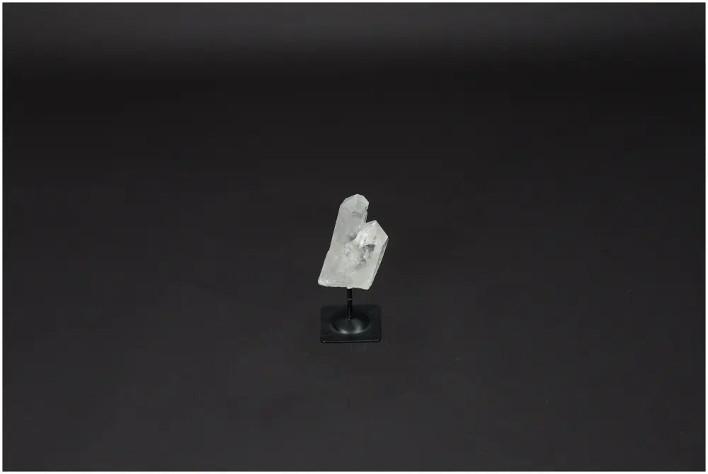 Lemurian Clear Quartz on metal stand, ideal for energy healing and purification, absorbs negative vibrations, and neutralizes radiation.