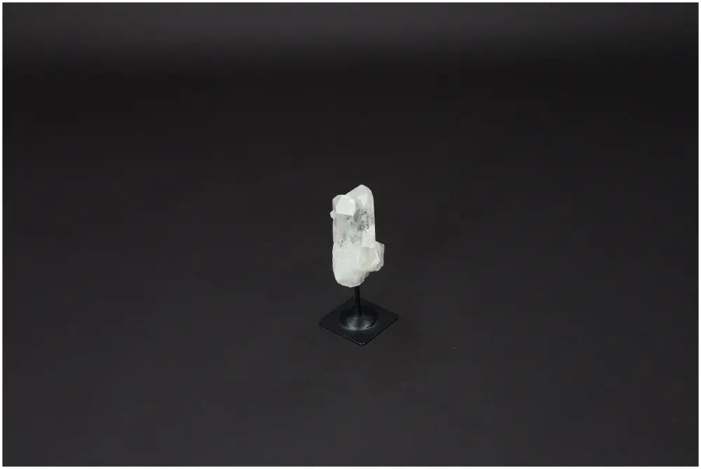Lemurian Quartz on metal stand against dark background, ideal for purification and energy harmonization.