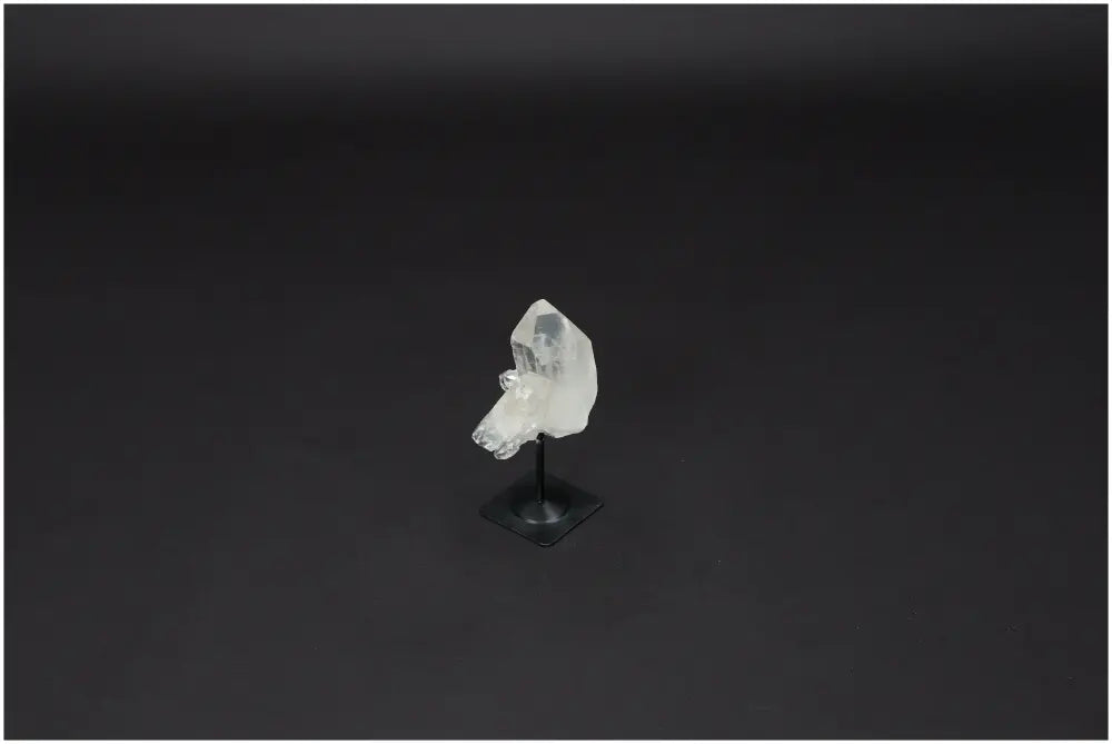 Lemurian Quartz on metal stand against a dark background, ideal for energy harmonization and purification.