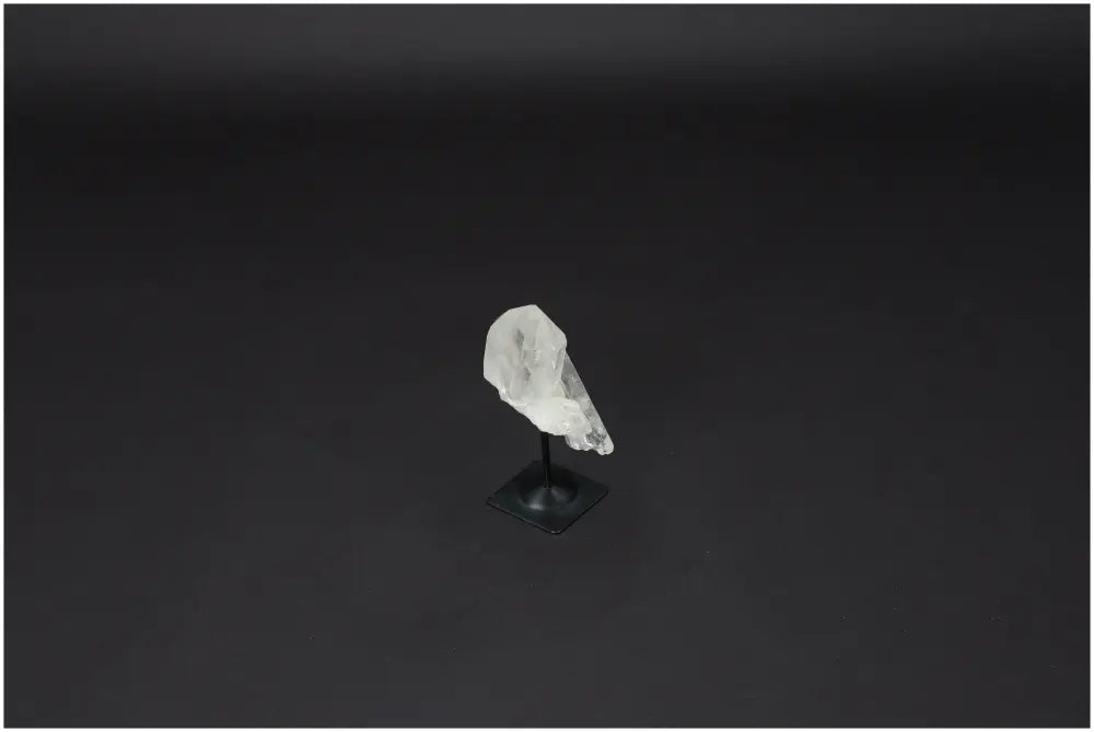 Lemurian Quartz on metal stand, perfect for purification and harmonizing energy, shown against a dark background.