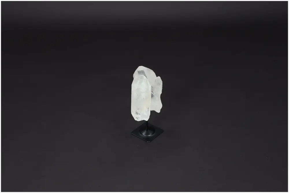 Lemurian Quartz on Metal Stand, known for energy purification and harmonizing benefits, against a dark background.