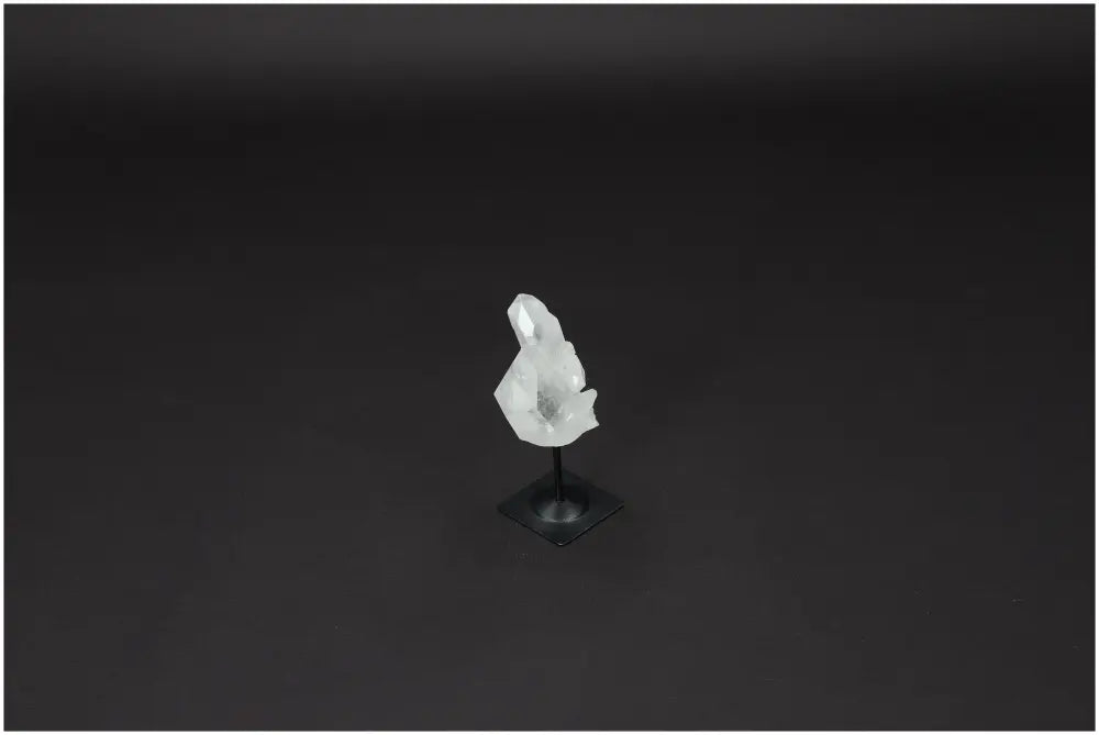 Lemurian Clear Quartz on metal stand, known for purification, harmonizing energy, and neutralizing negative vibrations.