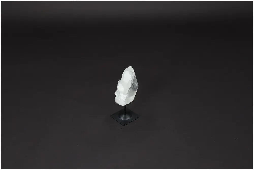 Lemurian Quartz on a black metal stand, ideal for energy purification and harmonizing space, against a dark background.