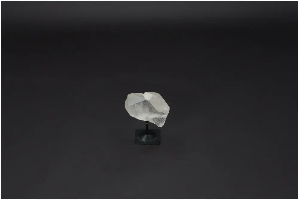 Lemurian Quartz on metal stand, showcasing clear quartz known for purification and neutralizing negative energy, ideal for any space.