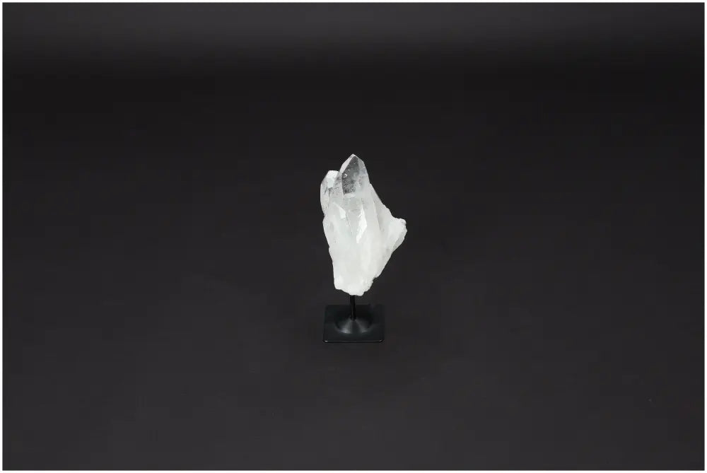 Lemurian Quartz crystal on a sleek metal stand against a dark background, showcasing its clear, purifying properties.
