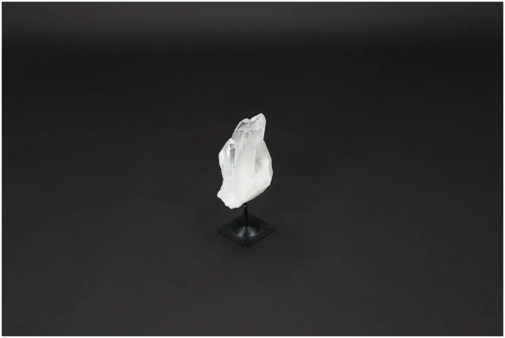 Lemurian Quartz crystal on metal stand, known for purification and neutralizing negative energy.