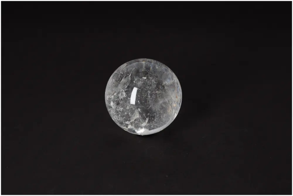 Lemurian Quartz Sphere with radiant energy and spiritual growth properties on black background, 6-7 CM in diameter.