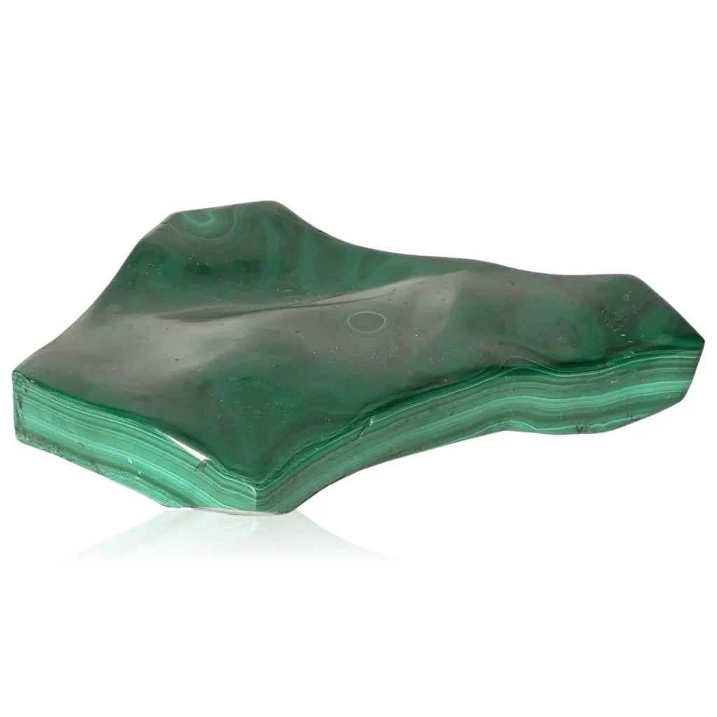 Vibrant green malachite stone showcasing natural patterns, synonymous with tranquility and courage; ideal for emotional support and transitions.