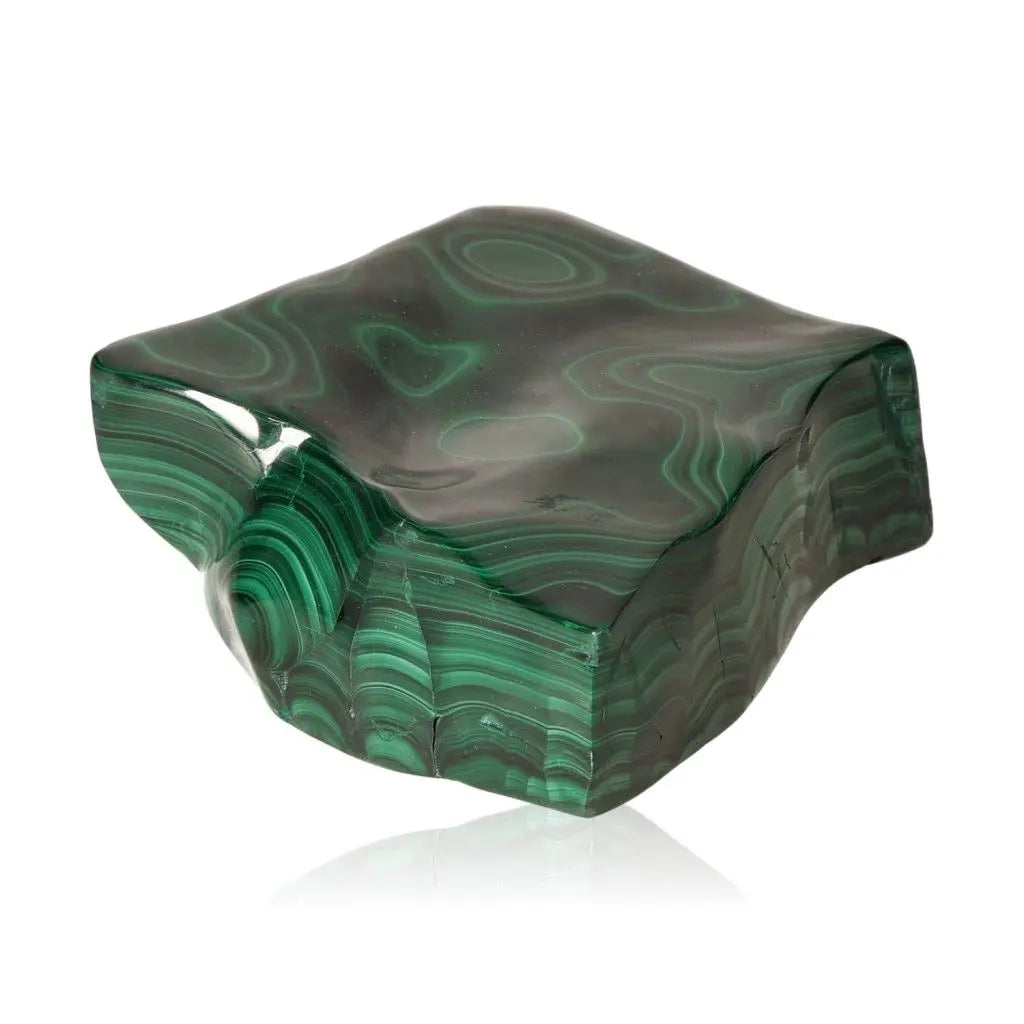 Polished malachite gemstone with verdant hues and swirling patterns, symbolizing serenity, courage, and hope.