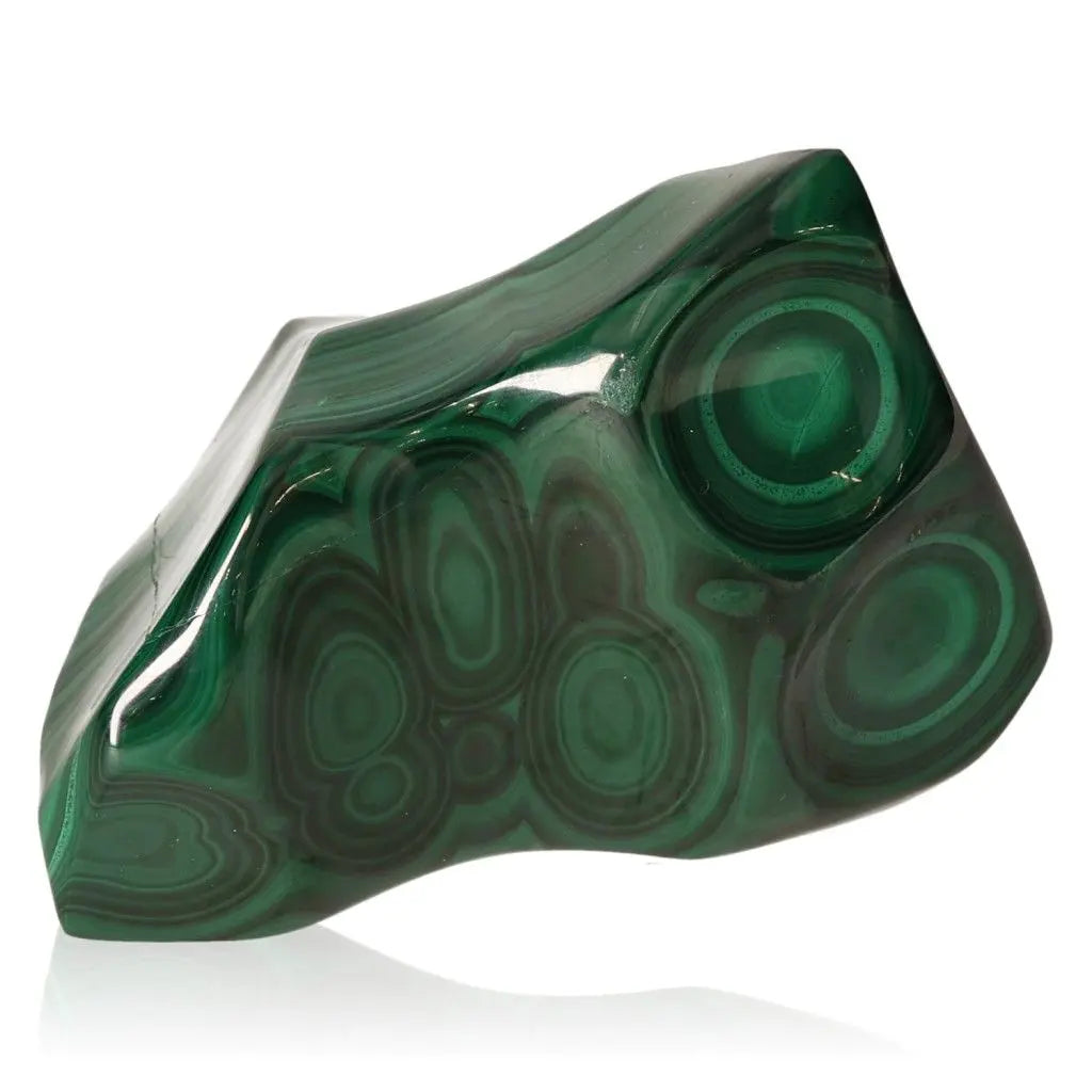 Malachite stone with dark green swirls, known for its beauty and spiritual benefits, symbolizing courage, hope, and transformation.