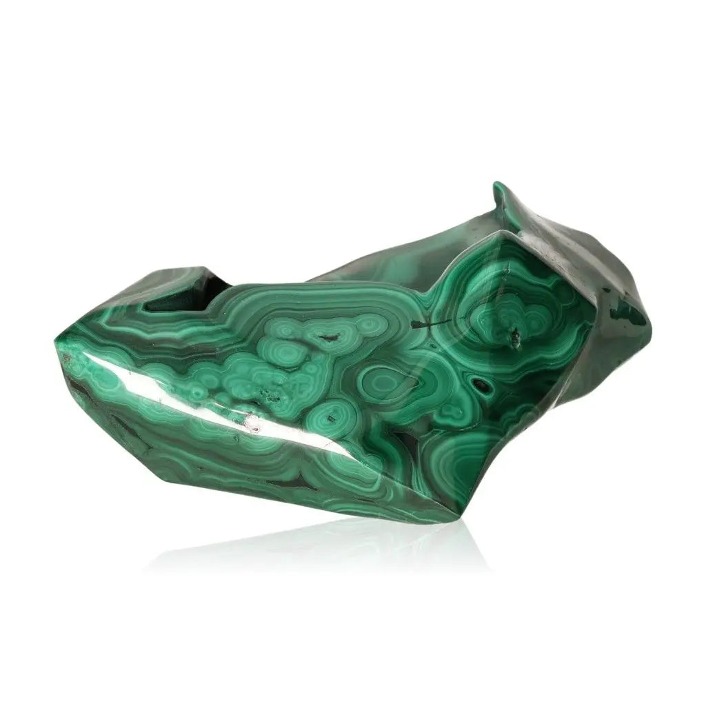 Shiny polished Malachite gemstone showcasing its vibrant green bands, symbolizing transformation and emotional balance.