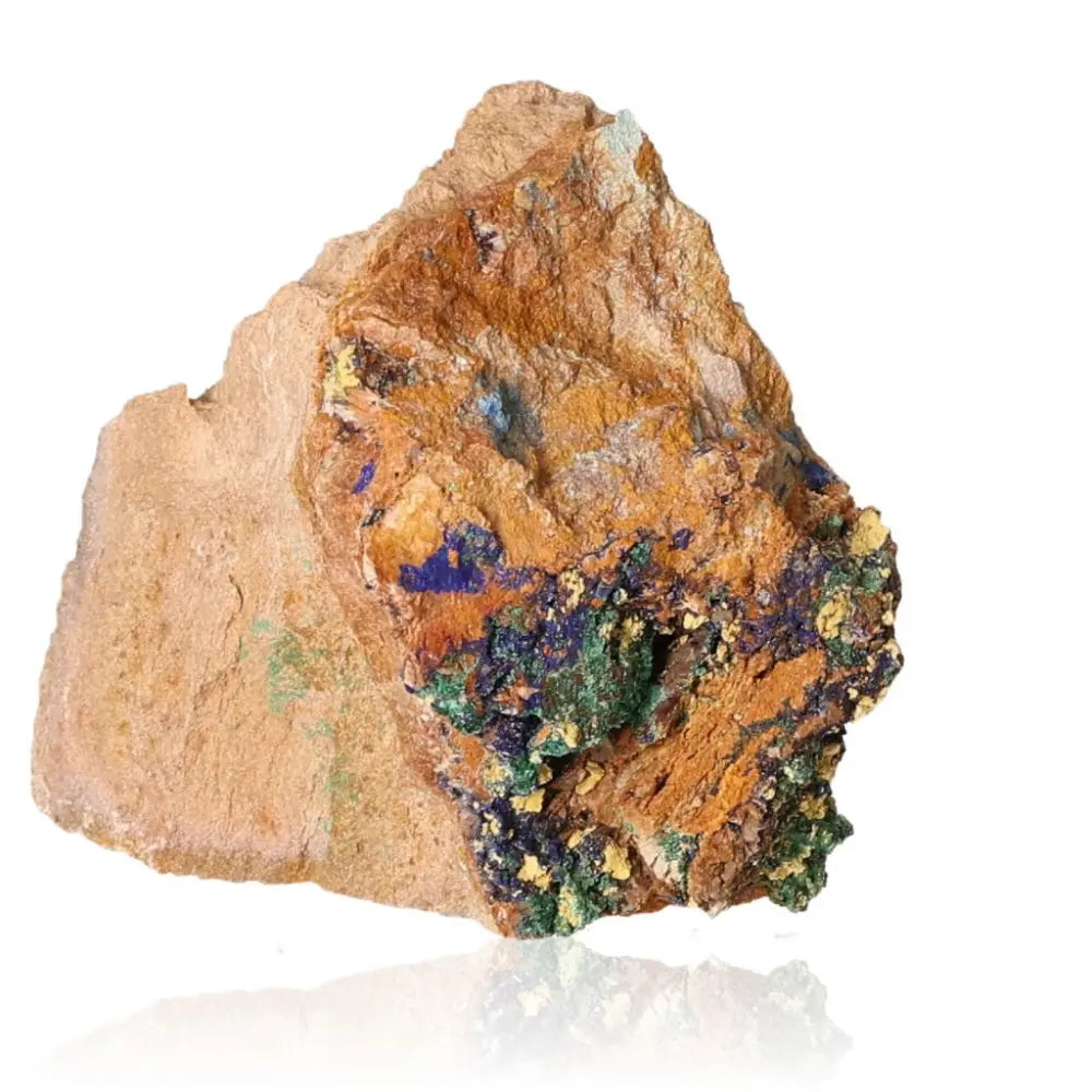 Raw malachite mineral sample with vibrant green and blue swirls on a rocky surface, showcasing natural beauty and uniqueness.