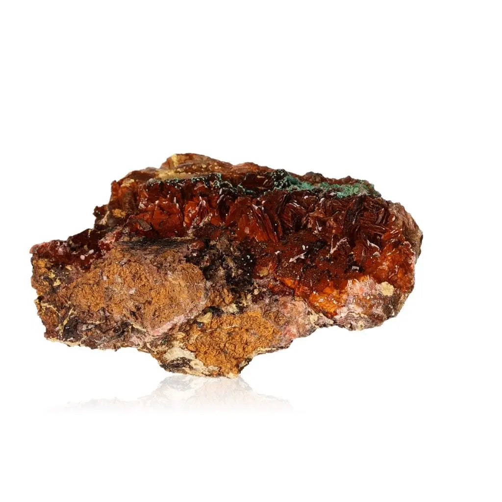 Raw red and brown crystal mineral rock on white background