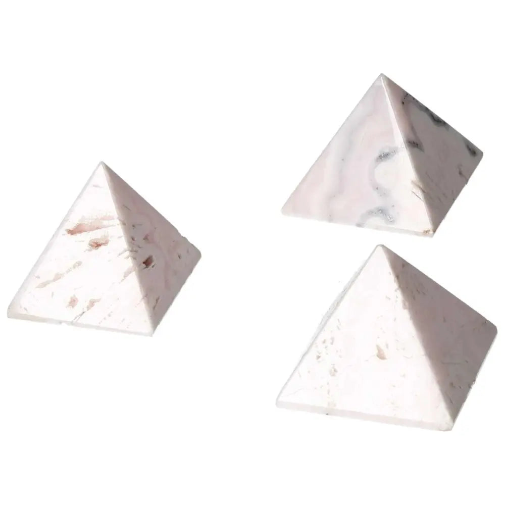 Manganocalcite pyramids for healing, boosting creativity, and enhancing peace, shown in elegant pink tones to clear negative energy.