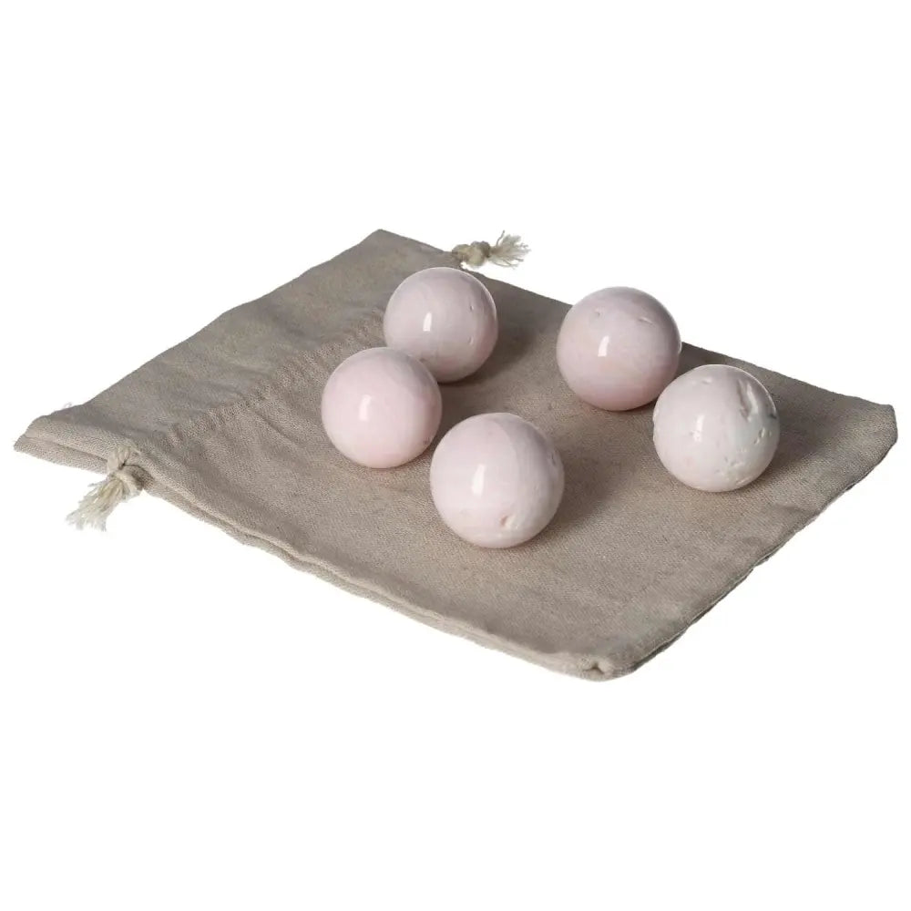 Manganocalcite Spheres on cloth bag, known for healing, positivity, and creativity enhancement.
