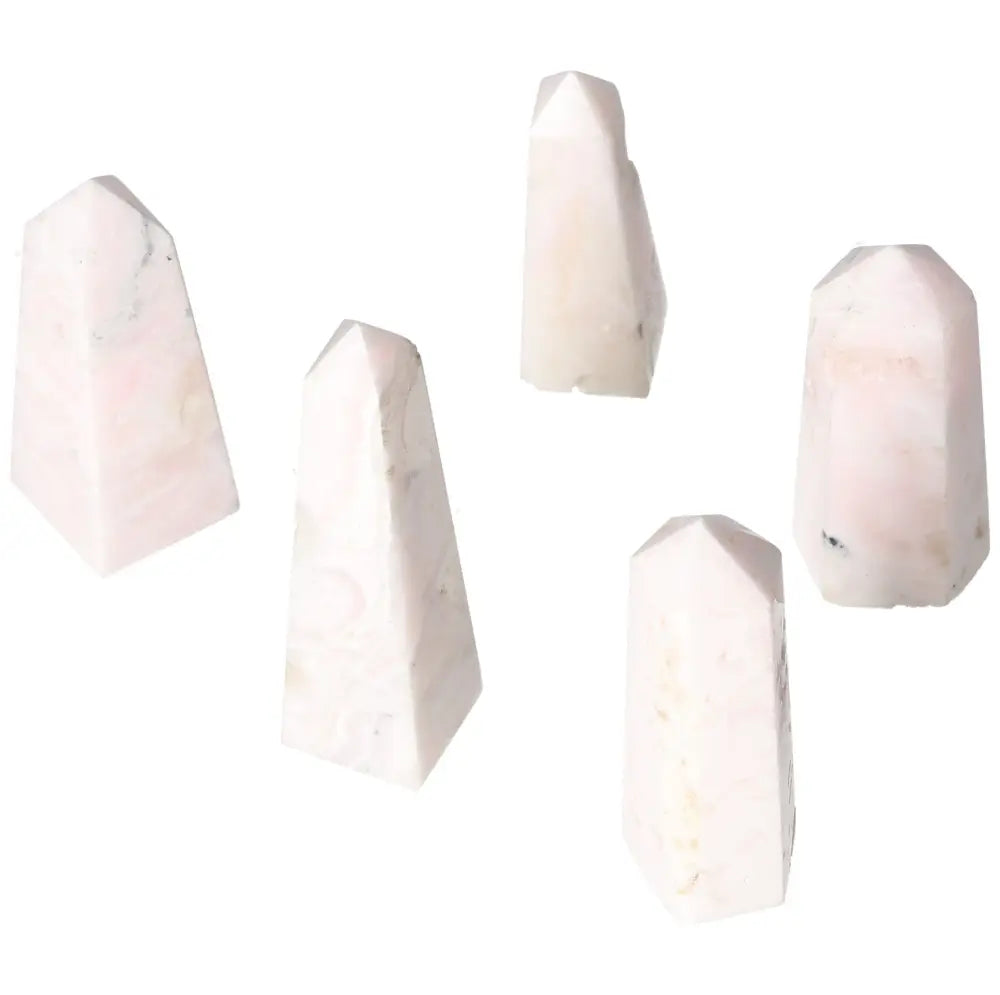 Five small Manganocalcite towers, healing crystals known for clearing negativity and boosting creativity and calmness.