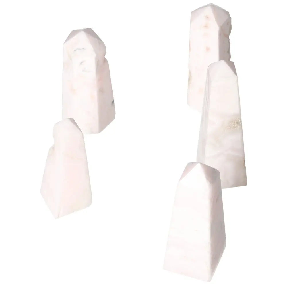 Collection of polished Manganocalcite towers promoting peace, creativity, and clearing negative energy, ideal for healing and meditation.