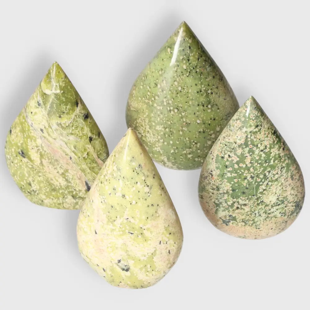 Medium Serpentine Drop crystals showcasing vibrant green hues for meditation and decor, emphasizing spiritual growth and emotional balance.