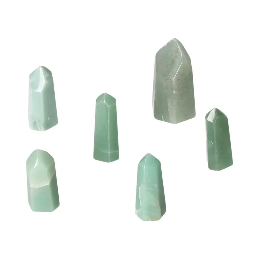 Collection of mini point green quartz crystals on a white background.