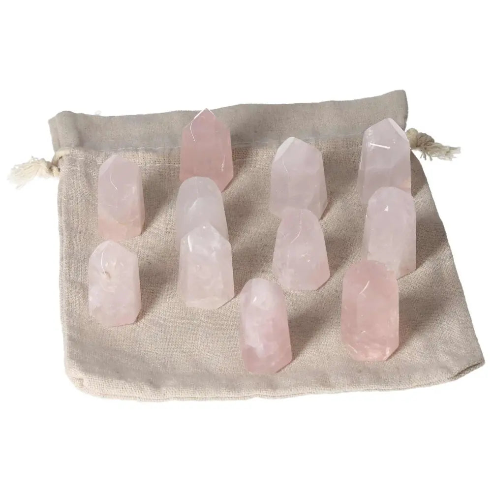 Mini rose quartz points on cloth bag, symbolizing love, compassion, heart healing, and emotional balance for heart chakra support.