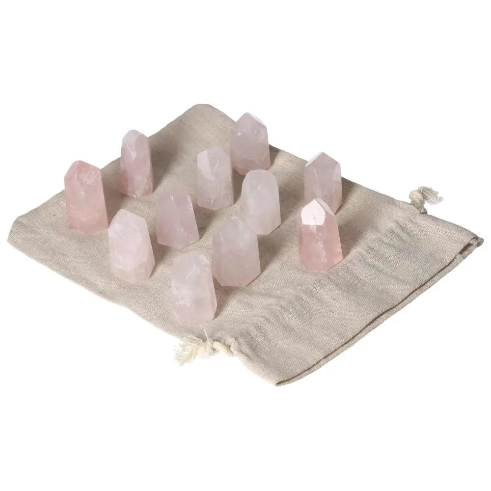 Mini Point Rose Quartz stones on a cloth bag, ideal for heart healing, love, and compassion support; promotes emotional balance.