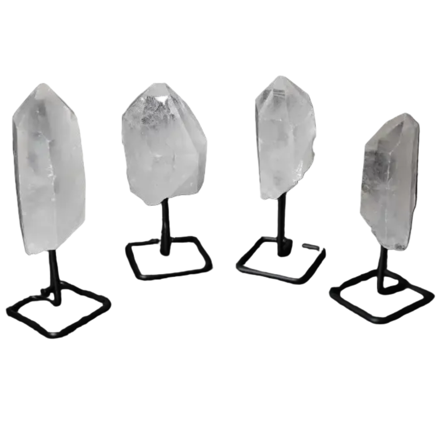 Four natural clear quartz points on modern stands, ideal for amplifying energy and enhancing clarity in meditation and energy work.