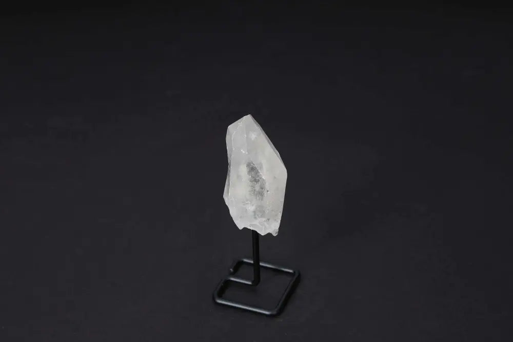 Natural Clear Quartz Point on modern stand, enhancing any space with energy amplification and clarity, ideal for meditation.