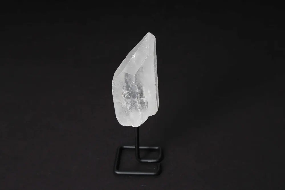 Natural Clear Quartz Point on Stand for energy amplification and clarity in meditation and manifestation practices.