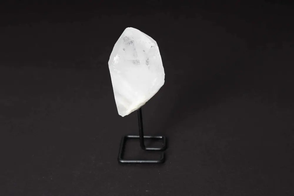 Natural clear quartz point on stand for energy amplification and clarity