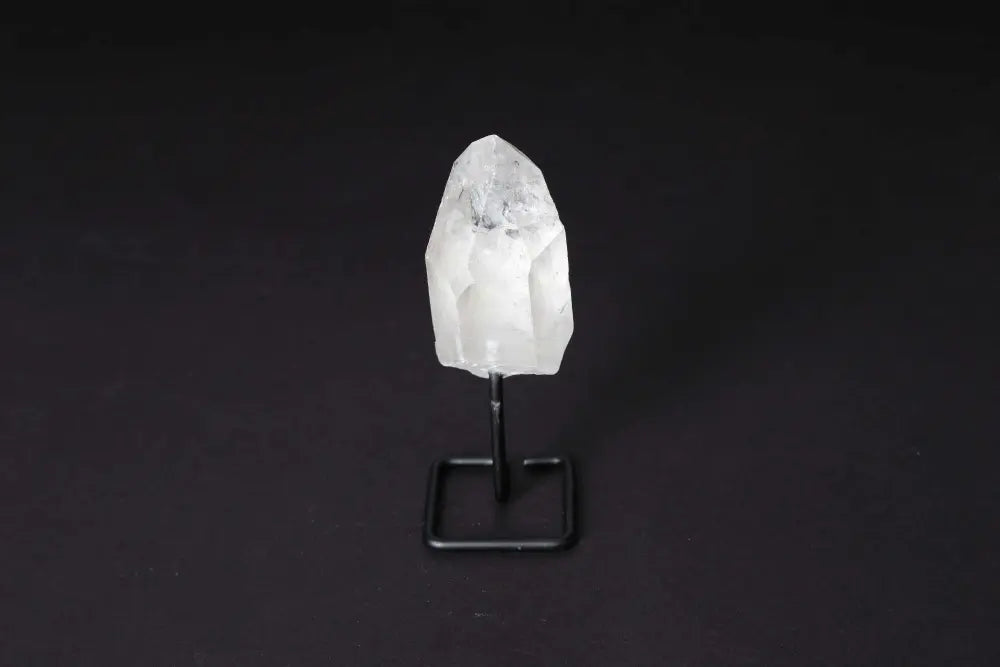Alt Tag: Clear Quartz Point on modern stand for meditation, energy amplification, and focus; ideal for home decor and healing practices.