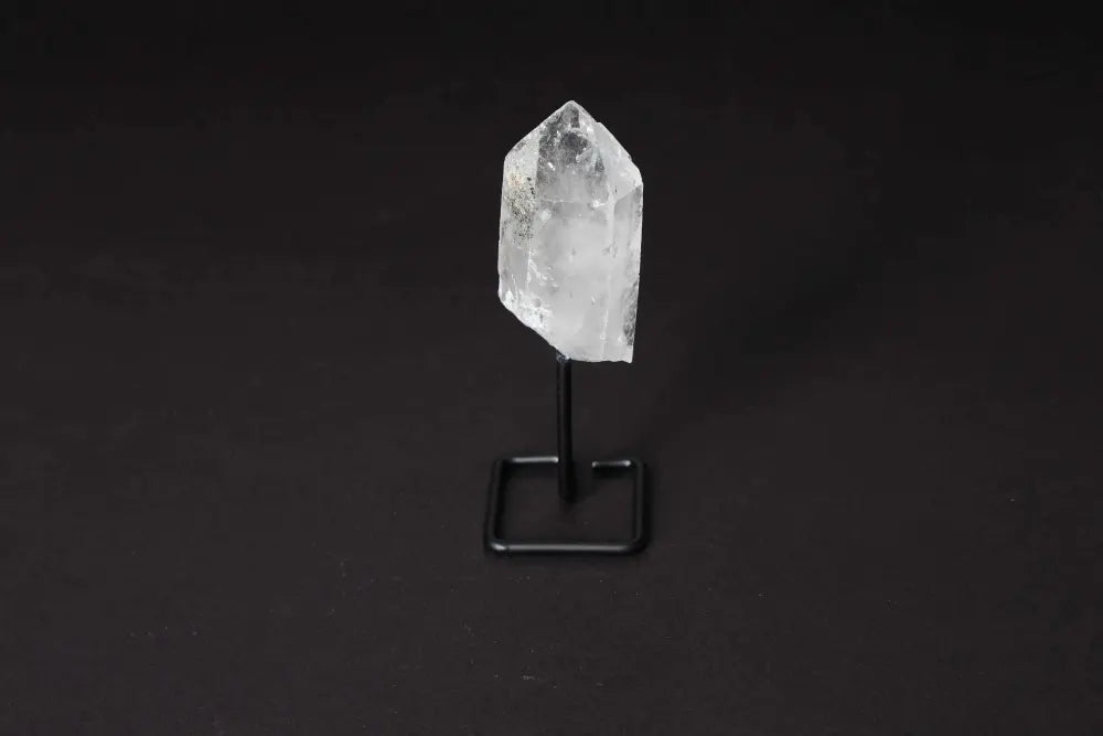 Clear Quartz point on a modern stand, enhancing energy and focus, ideal for meditation and decoration.